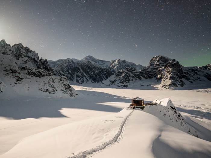 Against a backdrop of jagged mountain peaks and Northern Lights, the chalet looks small — but it has 2,000 square feet of space.