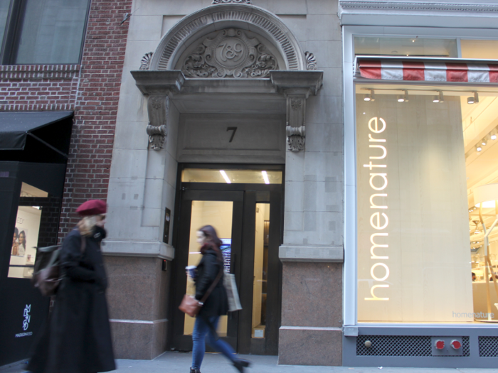 The entrance to the building where Trellis is located sits between a hair salon and a home décor store.