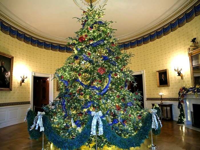 The official White House Christmas tree in the Blue Room stands at 18 feet tall.
