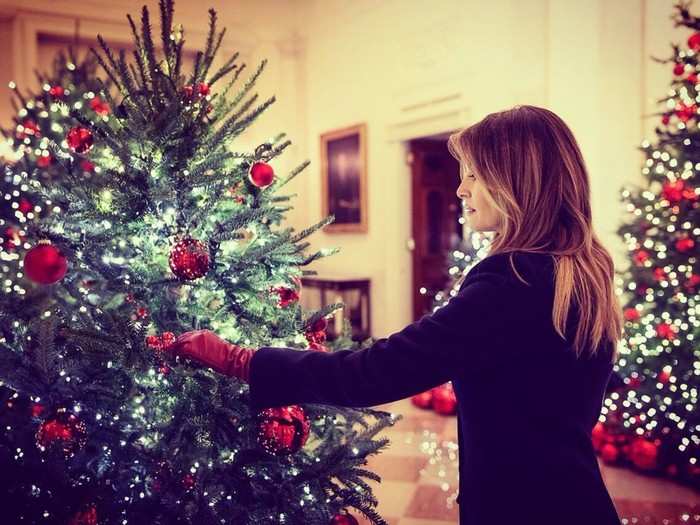 Melania shared a photo on Twitter of her fixing one of the patriotic ornaments. "The @WhiteHouse is sparkling for the Christmas season!" she wrote.