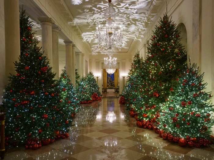 More than 14,000 red ornaments hang from 29 trees in the Cross Hall. The crimson color was chosen to take center stage as "a symbol of valor and bravery."