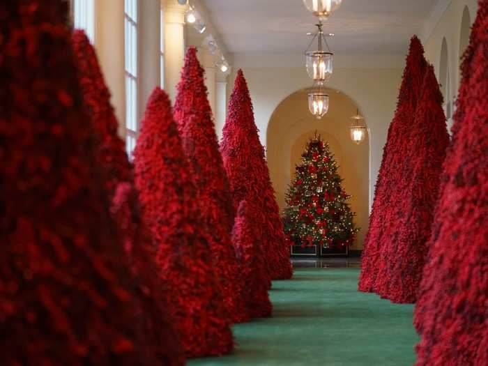 More than 40 topiary trees line the East colonnade in a striking red.