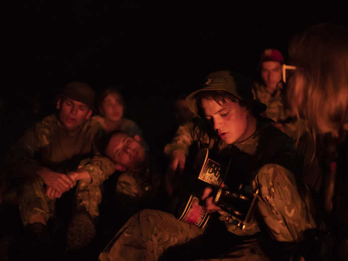 During a break in training, a teenager played a nationalist march on his guitar. It was decorated with a sticker showing white bombs hitting a mosque, under the motto, “White Europe is Our Goal.”