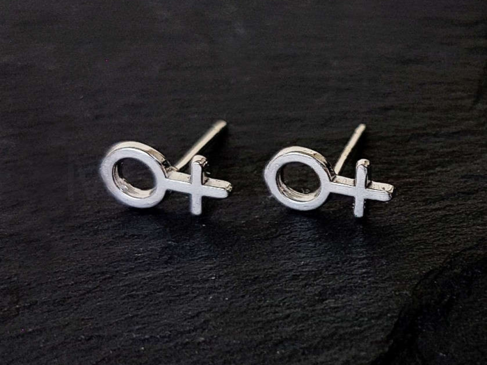 A pair of feminist earrings from a woman-owned Etsy shop