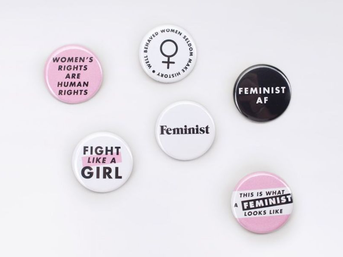 A set of feminist buttons from a brand that gives back to women with every purchase