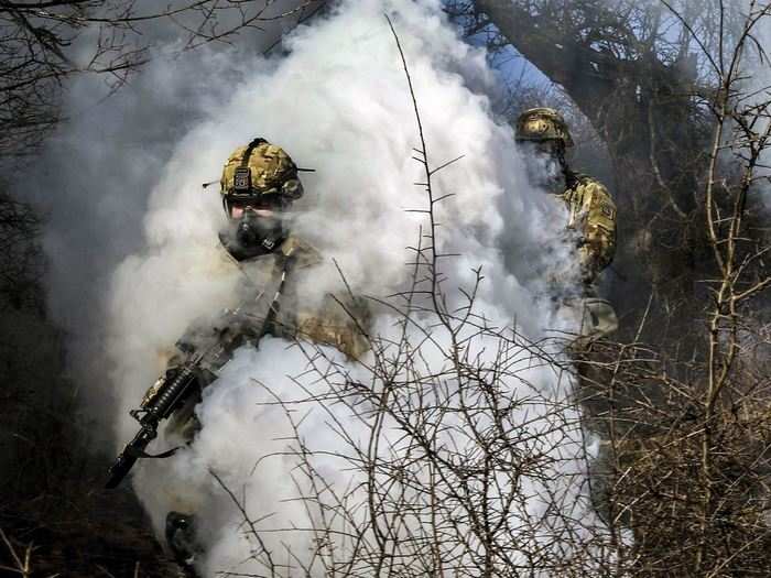 Soldiers push through smoke from a grenade during the ground tactical movement portion of the Operation Bowie Strike training exercise in Zhegoc, Kosovo on Jan. 19, 2018.