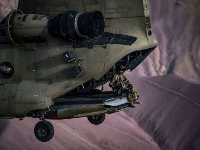 A U.S. Army Task Force Brawler CH-47F Chinook flight engineer sits on the ramp while conducting a training exercise with a Guardian Angel team assigned to the 83rd Expeditionary Rescue Squadron at Bagram Airfield, Afghanistan on March 26, 2018.