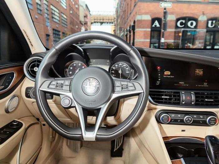 Analog/digital gauges and a flat-bottomed, leather-wrapped steering wheel combine with the airy interior to join performance prowess with premium-ness. Note the stop-start button on the wheel, a la Ferrari.