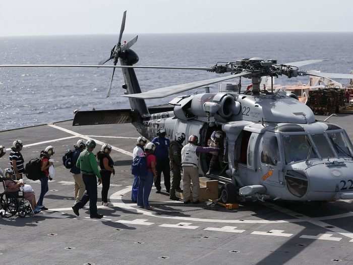 Patients load into an MH-60 Sea Hawk to be flown back to shore.