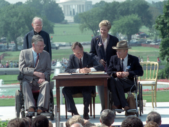 He signed the Americans with Disabilities Act in 1990, forbidding employers from discriminating against people with disabilities.