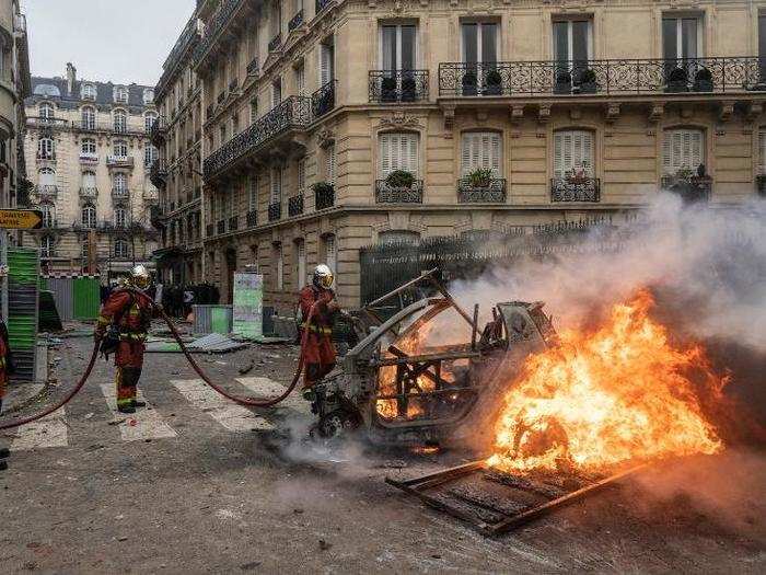 Firefighters worked to extinguish flaming cars in the center of the city.