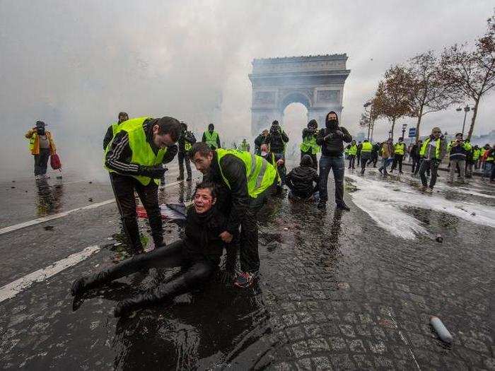 A woman was wounded by a water canon as protesters clashed with riot police.