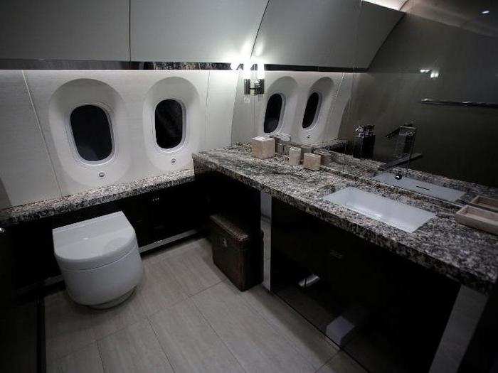 Here is a look at a restroom on the plane complete with stone countertops.