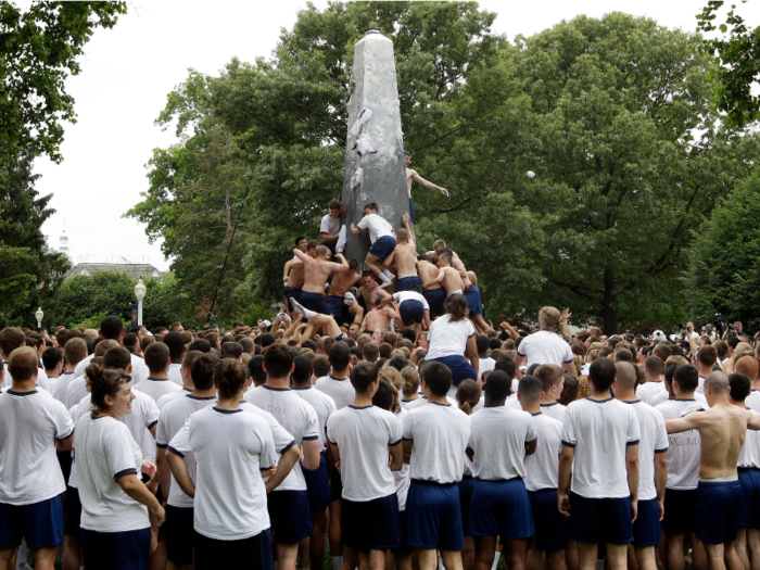 The plebes then climb a monument called Herndon, which their upperclassmen have greased with tubs of lard, to replace the iconic 