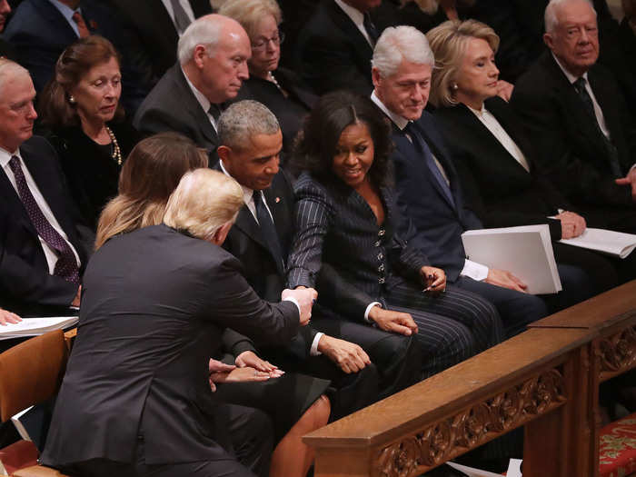 They were greeted by the Obamas, who were seated between the Trumps and Clintons.