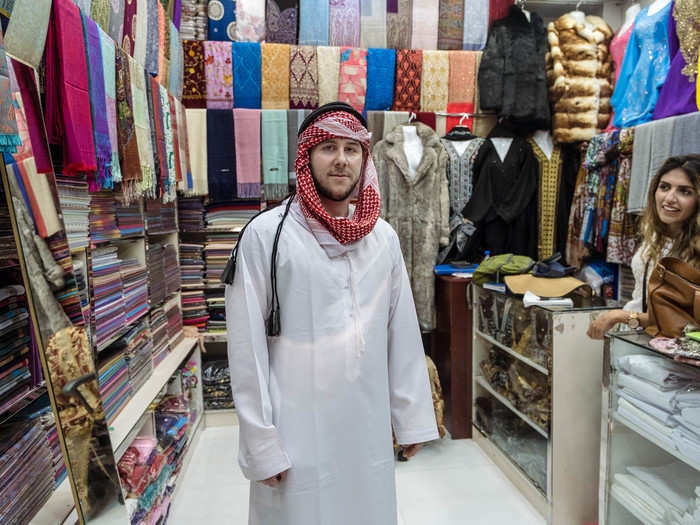 Khan convinced me that I had to try on the traditional Emirati keffiah and kandora. The Emirati kandora is collarless and features a long tassel known as a tarboosh.