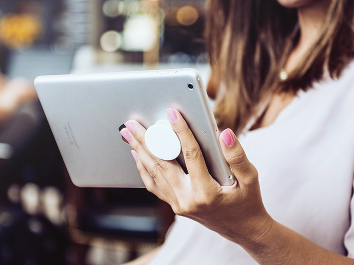 A grip to hold an ebook reader, phone, or tablet while reading