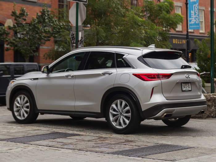 The rear end is dominated by the twin exhaust outlets, a subtle roof-top spoiler, and a liftgate.