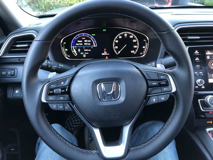 The leather-wrapped steering wheel feels great, and the digital-analog gauges are what one would expect from Honda, a carmaker that