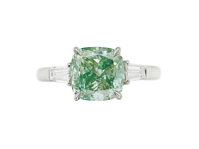 A cushion-cut fancy vivid green diamond ring of 3.01 carats sold for $972,500.