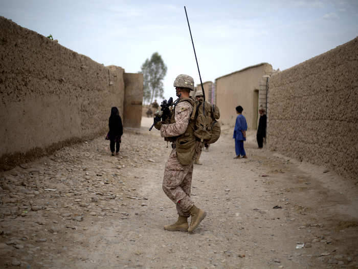 A US Marine with Task Force Southwest moves through a village during a patrol near Bost Kalay, Afghanistan in June 2018.