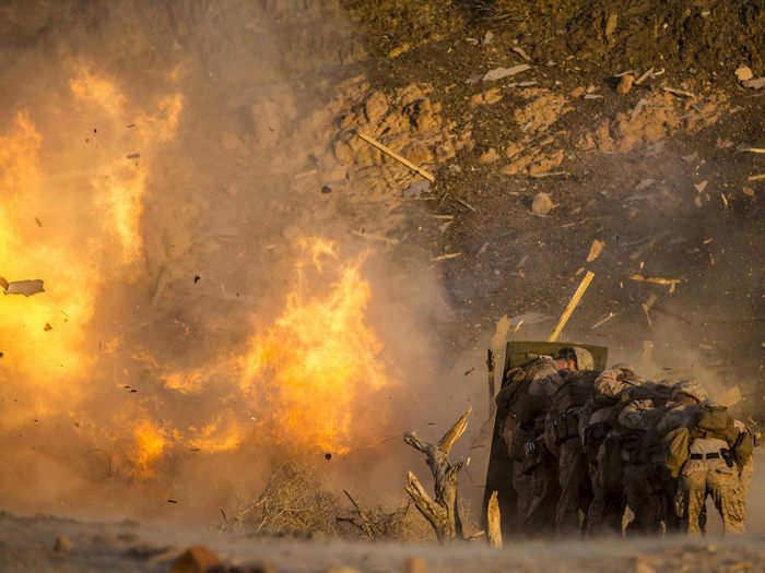 Marines take cover from demolitions during sustainment training at Camp Titin in Jordan on July 8, 2018.