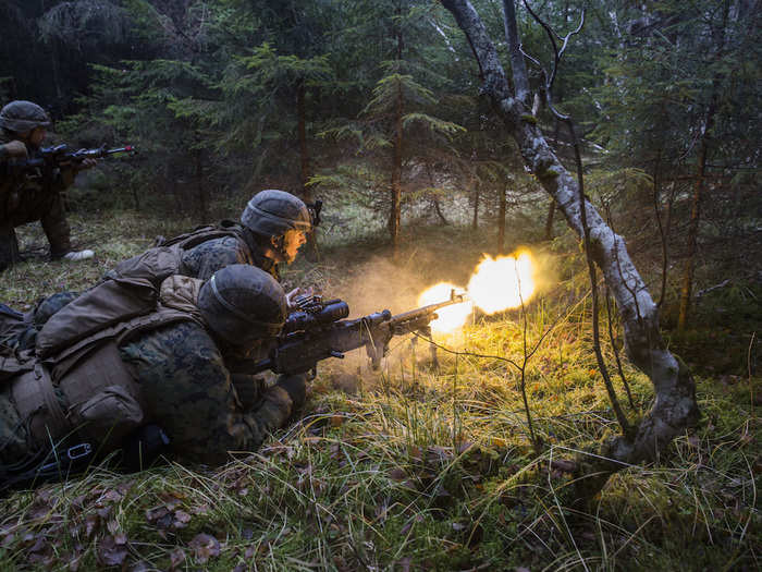 US Marines Cpl. Justin Droll and Lance Cpl. Stephen Luzier assault an enemy position during exercise Trident Juncture 18 in Norway on Nov. 7, 2018.