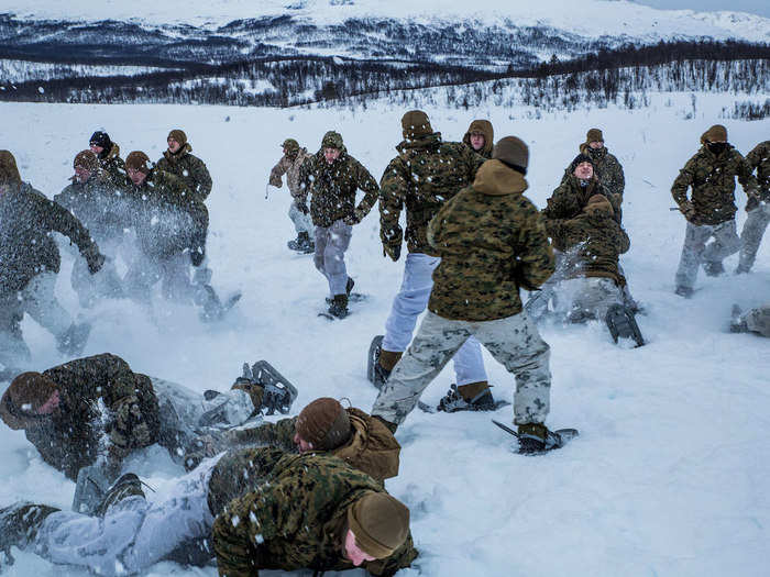 Marines play a game of bulldog to keep warm in the harsh weather during exercise White Claymore in Bardufoss, Norway on Feb. 7, 2018.