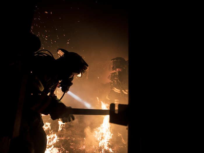 Firefighters battle a blaze during live burn training at the Anthony "Tony" Canale Training Center in Egg Harbor Township, New Jersey on Sept. 18, 2018.