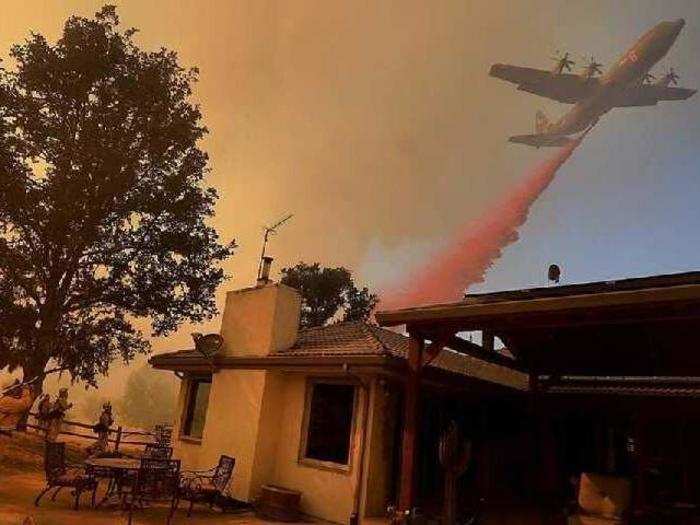 A Modular Airborne Fire Fighting System (MAFFS), a C-130 Hercules modified for fire-fighting purposes, releases fire retardant over Shasta County, California, during the Carr Fire in early August 2018.