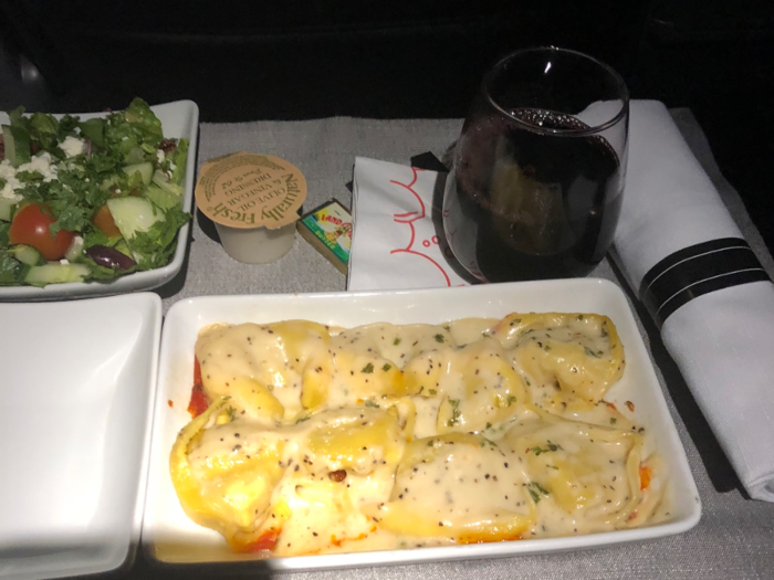 But in domestic first-class, you should be prepared for meals more akin to reheated tortellini and a dry salad.