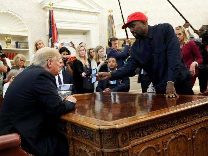 Rapper Kanye West shows President Donald Trump his mobile phone during a meeting in the Oval Office. Labeled widely as "bizarre," West