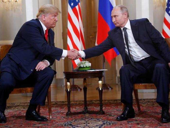 U.S. President Donald Trump and Russian President Vladimir Putin shake hands at the beginning of a meeting at the Presidential Palace in Helsinki.