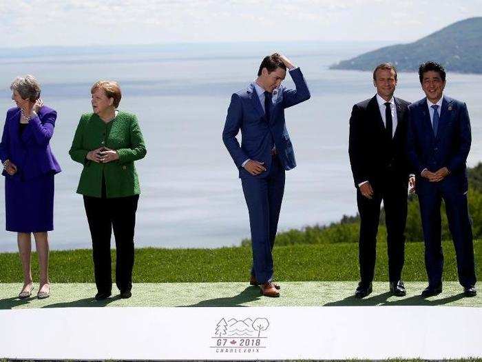 World leaders wait for U.S. President Donald Trump to join them for a family photo at the G7 Summit.