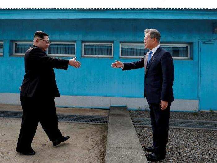 South Korean President Moon Jae-in and North Korean leader Kim Jong Un shake hands at the truce village of Panmunjom inside the demilitarized zone separating the two Koreas.