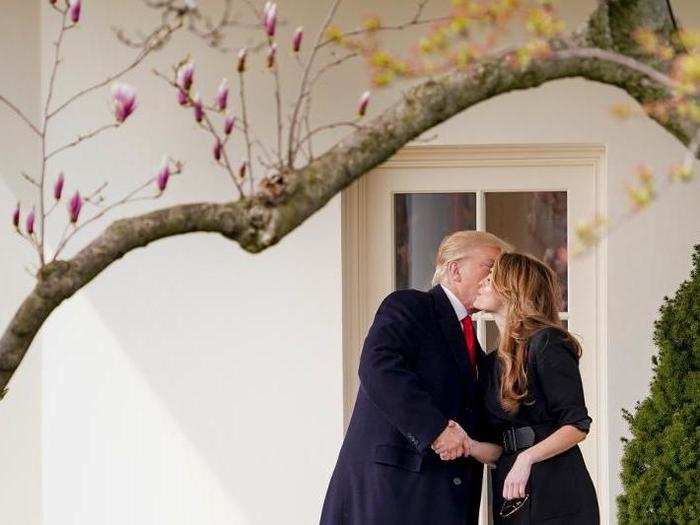 President Donald Trump kisses White House communications director Hope Hicks on her last day before boarding Marine One.