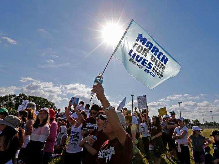 Eric Lin of Parkland, Florida, holds a flag as he takes part in the March For Our Lives-Parkland, one of hundreds of anti-gun violence demonstrations held by students across the world.