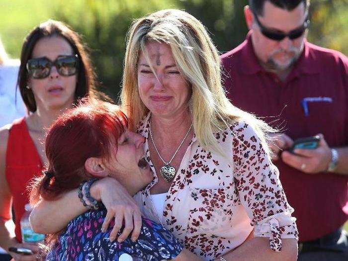 Parents wait for news after a reports of a shooting at Marjory Stoneman Douglas High School in Parkland, Florida. The shooting left 17 dead and launched a national pro-gun control movement.