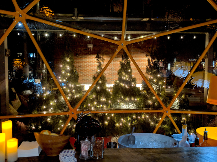 Christmas trees outside of the snow globe helped illuminate the bar area.