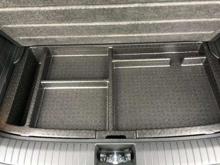 Under the cargo floor is a storage tray which...