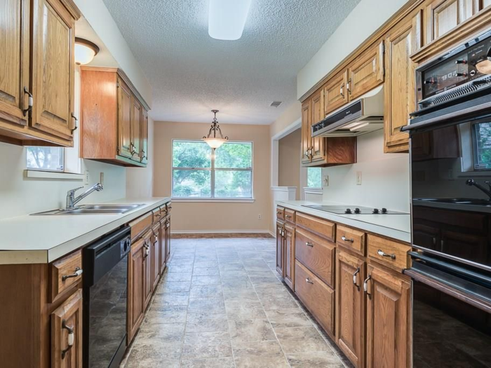 And then there was the kitchen in her fifth flip, which had dark cabinets, cracked windows, popcorn ceilings, and outdated appliances.