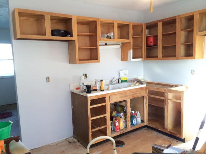 The walls were finally replastered and painted. At this point, Monroe started washing and sanding the cabinetry to prepare painting them.