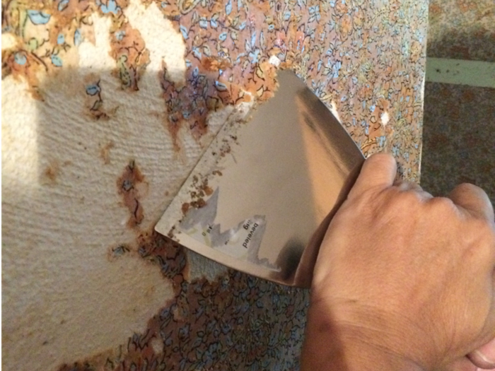 The first step was scraping off the dated wallpaper.