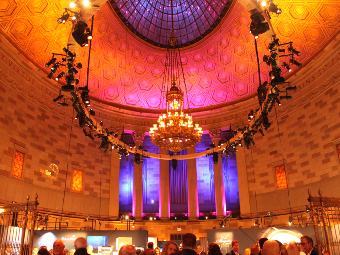 The interior of the building was stately, with a high, domed ceiling, chandeliers, and warm lighting.