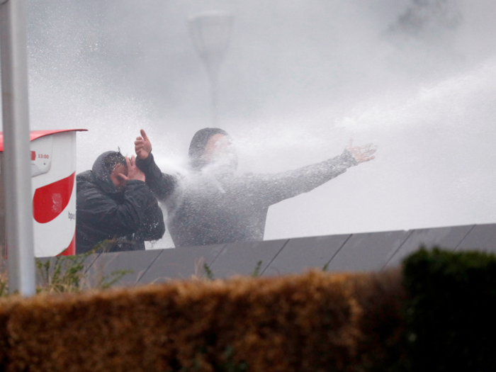 One activist was hit the face by the jet of water.