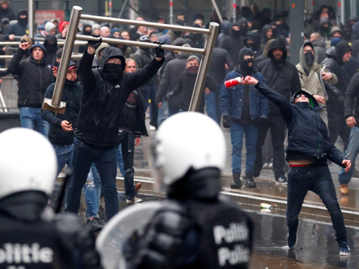 Tensions escalated as protesters ripped up street signs and metal railings as they clashed with police. Some demonstrators threw items at police.