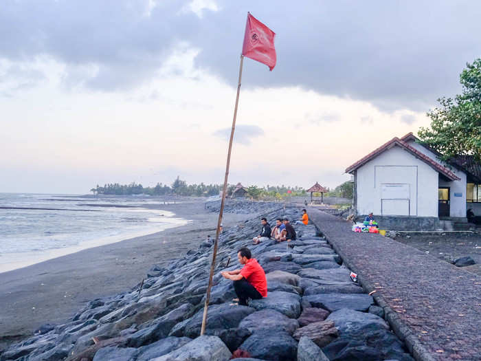 Eventually, I hit Lebih Beach, a black sand beach facing the Indian Ocean. I paid a few  rupees to park the bike and walked out to the water. The sun was setting.