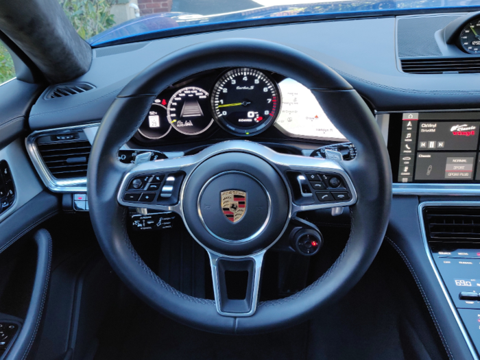 In front of the driver is a sculpted Porsche steering wheel.