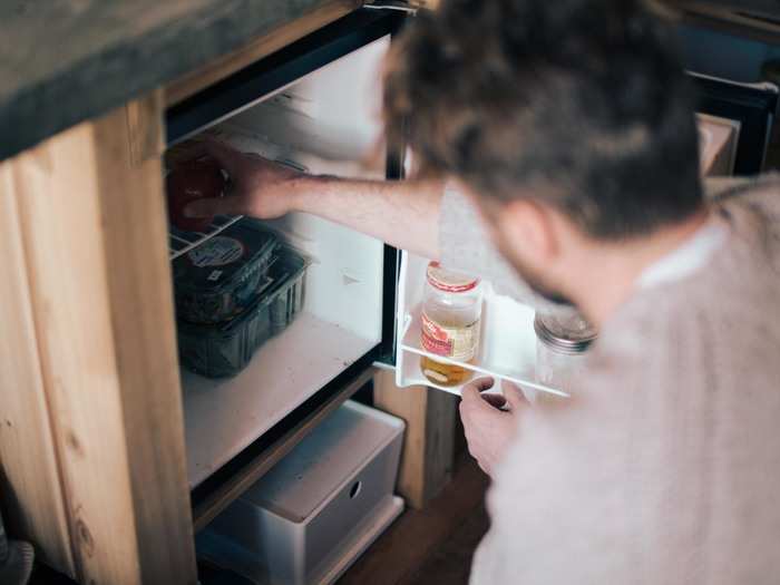 For lunch, he comes back to the tiny house and gathers ingredients from a mini fridge — half the size of a bar fridge. "It