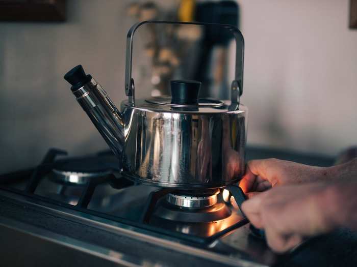 Duncan makes coffee on his two-burner propane stove before heading to work around 8 a.m.